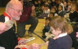 Governor, Mr Alan Huckle distributed commemorative coins to children in the Community School