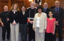Cherie Clifford (forth from right) and her family with Cllr Robertson, HE the Governor, Principal Immigration Officer P. King and referee B. Watson