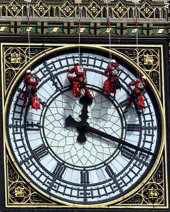 Glaziers abseil down the clock face