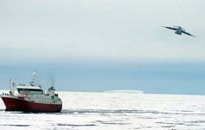 A US Air Force plan drops engine parts to a trawler trapped in the ice in the Ross Sea.