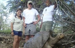 US movie star Richard Gere, center, poses for pictures next to 'Lonesome Jorge', a giant tortoise in the Galapagos Islands, Ecuador. The woman at left and the man at right are park guides. (AP Photo)