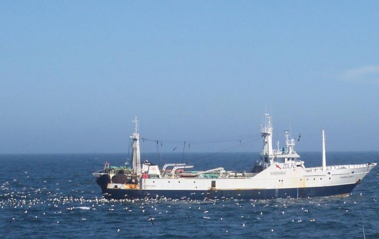 A trawler is followed by seabirds while discarding fish offal