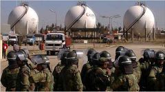 Bolivian soldiers stand watch next to the nationalized companies