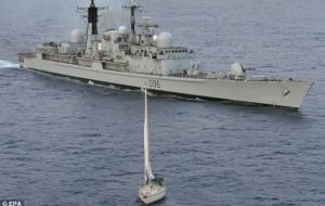 HMS Gloucester looms over the yacht Tortuga whilst a Cape Verde law enforcement team searches for narcotics on board


