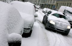 A blanket of snow covers homes, vehicles and roads 