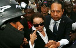 Jean-Claude 'Baby Doc' Duvalier and his partner, Veronique Roy, leave court. (Photo AFP/Getty Images)