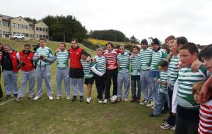 Rugby players with Falkland’s children at the School playground