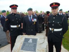 FIDF members Zoran Zuvic and Dustin Clarke with Gary Clement in front of the Memorial stone to the three Islanders who died in 1982.
