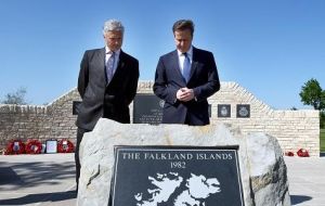 David Cameron is accompanied by NMA chief executive Charlie Bagot-Jewitt during a visit to the Falklands Memorial (Photo: AP)