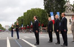 The French president takes the salute from the troops at the annual parade 