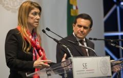 Ministers Ildefonso Guajardo and Debora Giorgi (L) exchange compliments