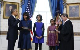Obama taking the presidential oath at the Blue Room with his family