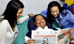  Hugo Chavez and his daughters, as he holds a copy of Cuba's state newspaper Granma in Havana, Cuba, Thursday, Feb. 14.2013