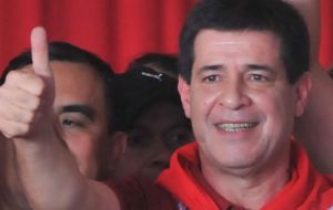 President elect Cartes with the red colour of the party celebrates victory  