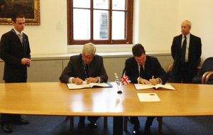 David Gauke, Exchequer Secretary to the UK Treasury and Ambassador Julio Moreira Morán sign the agreement