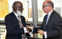 Elrington and Timerman congratulate each other following the agreement 