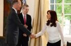 The president wearing a white blouse and dark trousers