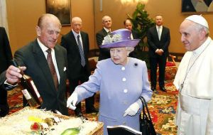 Prince Philip holds a bottle of Balmoral whiskey from the royal estate in Scotland