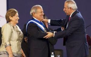 The presidential sash was presented to Sanchez Ceren by the head of the National Assembly, Sigfrido Reyes
