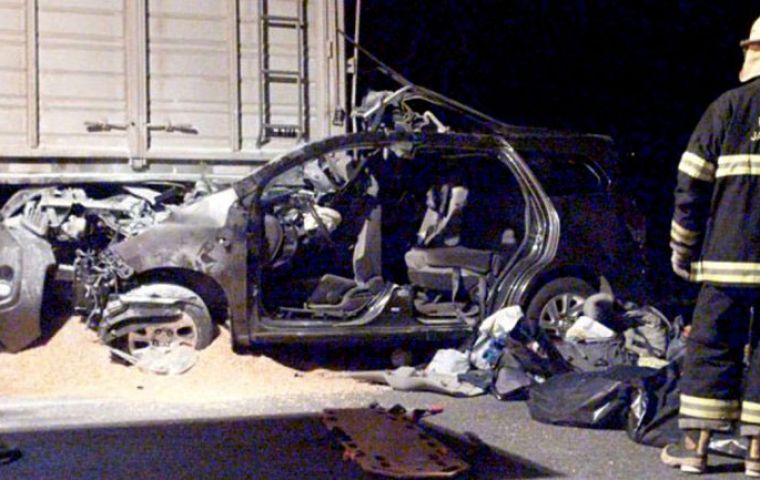 The remains of the car that crashed into a grain truck and caught fire 