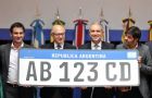 Timerman and other officials hold the enlarged prototype of the Mercosur cars' number plate