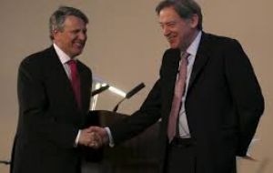Ben van Beurden, CEO of Shell and Andrew Gould, Chairman of BG Group shake hands as Shell and BG their takeover deal at the London Stock Exchange