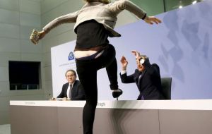 The news briefing was interrupted by a female protester screaming: ”End ECB dictatorship.'' She rushed onto the stage but finally she was dragged off by security officials
