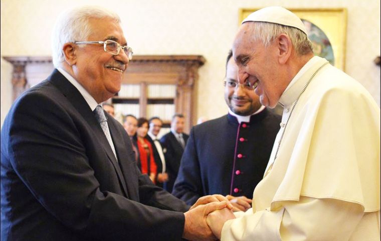 Pope Francis shakes hands with Palestinian Authority chief Mahmoud Abbas during a visit to the Vatican
