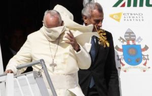 When Francis emerged, a breeze whipped off his white zucchetto cap and swirled his robes, but the pope took it in his stride, smiling and laughing