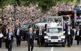  Francis waved to the crowd surging against barricades as the pope-mobile made the 15-minute trip. Some 80,000 people received tickets to the processional. 