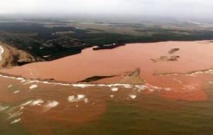 The dense orange sediment in the river reached the ocean on the weekend, hurting local tourist businesses and coastal fishing