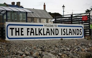 The Welcome to the Falklands sign next to the pier which receives tourists 