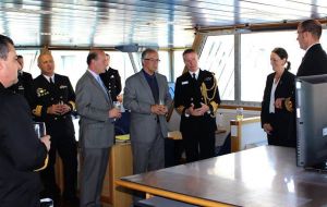 Defense minister Jorge Menendez (with glasses) and officers hosted by Captain Angus Essenhigh RN at the bridge of the visiting vessel