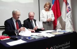MLA Dr. Elsby signs the MOU with Pedro Pfeffer, (center) President of the Executive Council, while UCBC Vice-Chancellor Maria Cristina Brieba looks on.