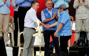 FARC rebel leader Rodrigo Londono, also known as Timochenko, Colombian President Juan Manuel Santos and Jean Arnault, the UN Secretary-General's Special Representative for Colombia and Head of the UN 