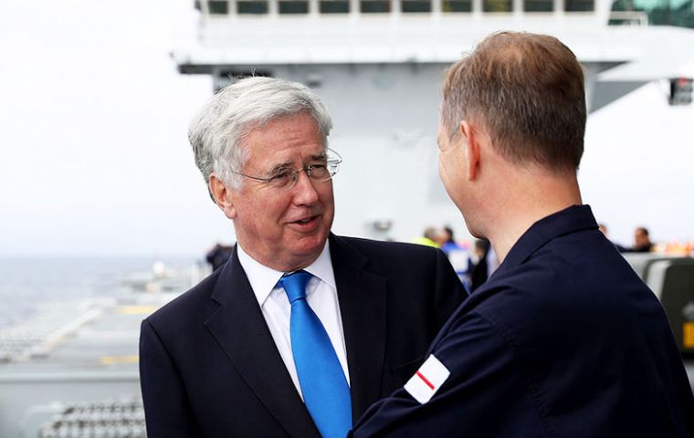 Sir Michael Fallon with officers from HMS Queen Elizabeth