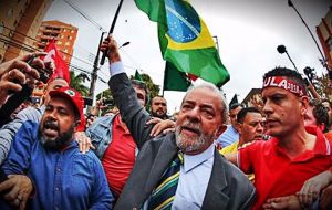 Supporters of Lula, many wearing the trademark red of his Workers' Party, gave him a rock star's welcome as he made his way through the crowd to enter the court