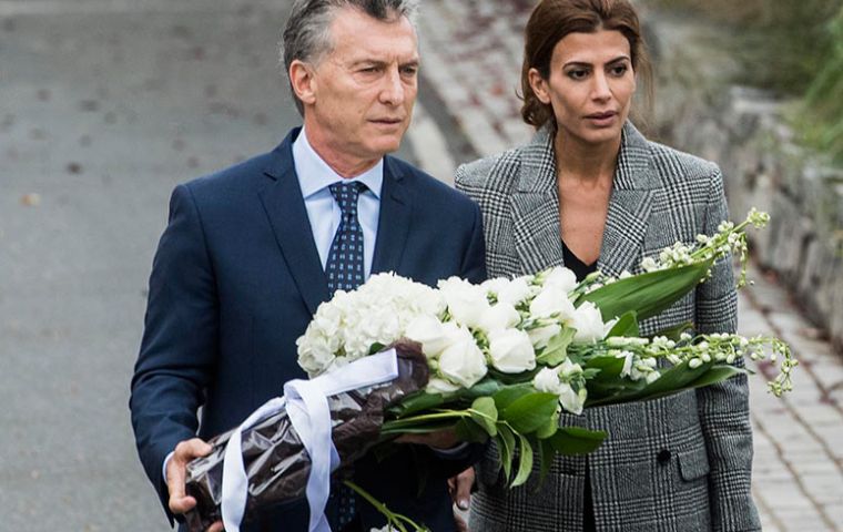 “Unfortunately, five families were destroyed” in this “cowardly attack,” Macri said, laying a wreath of white flowers at the site alongside his wife. 