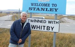 Jorge Lidio Viñuela during a visit to the Falkland Islands, pictured at an iconic signboard at the entrance of Stanley 