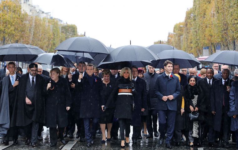 Macron and dignitaries walked to the Tomb of the Unknown Soldier, a memorial to France's fallen under the Arc de Triomphe, in the rain under black umbrellas (Pic AP)