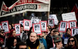 The protest began in central Santiago, with many demonstrators carrying red carnations and holding photos of loved ones who were killed or disappeared