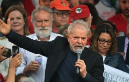 Lula wearing a black T-shirt and suit jacket, pumped his fist in the air as he exited the federal police HQ in Curitiba and was mobbed by hundreds of supporters