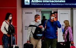 An arrival gate in Argentina with people using masks against the Covid-19 pandemic.