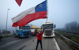 Several points of the main highway headed south were also blocked by trucks parked across the road as drivers stood alongside with Chilean flags