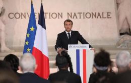 In the Paris Pantheon, a mausoleum to France's heroes, Macron handed five new citizens their French papers in a solemn ceremony