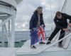 Mensun Bound, Director of Exploration and Simon Frederick Lighthelm, Ice pilot of the expedition raise the Falklands flag on the SA Angulhas II.