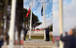 The Red Ensign and the Falklands national flag are raised at Victory Green