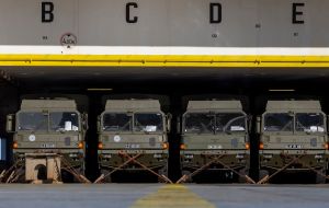 Military vehicles strapped to the ship's hold  