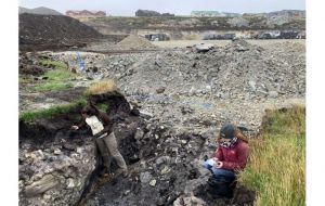 Dr. Zoë Thomas and Dr. Haidee Cadd examining ditch at Tussac House site where prehistoric tree remains were found. Credit: Dr. Zoë Thomas