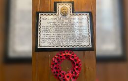 A poppy wreath hangs from the memorial tablet of those lost on November first 1914 from HMS Good Hope and HMS Monmouth.